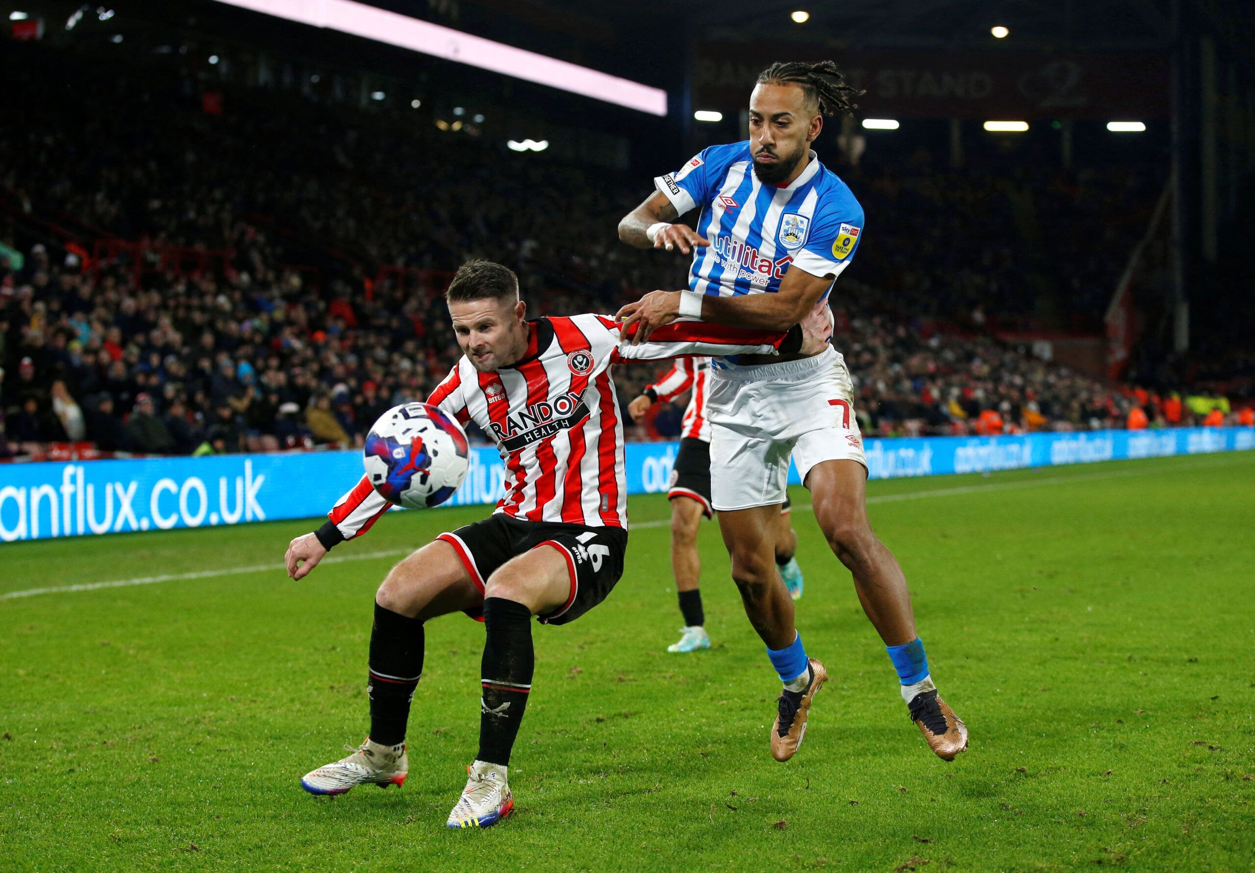 Soccer Football - Championship - Sheffield United v Huddersfield Town - Bramall Lane, Sheffield, Britain - December 10, 2022  Sheffield United's Oliver Norwood in action with Huddersfield Town's Sorba Thomas  Action Images/Ed Sykes  EDITORIAL USE ONLY. No use with unauthorized audio, video, data, fixture lists, club/league logos or 