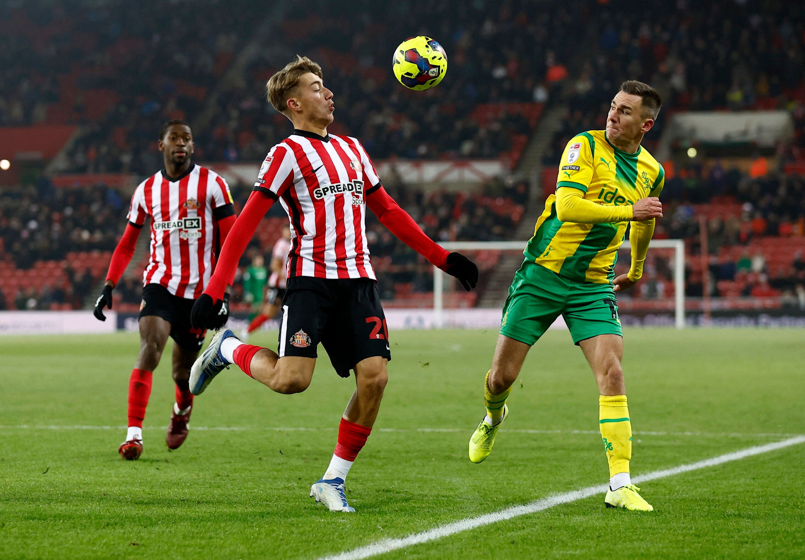 Soccer Football - Championship - Sunderland v West Bromwich Albion - Stadium of Light, Sunderland, Britain - December 12, 2022 Sunderland's Jack Clarke in action with West Bromwich Albion's Jed Wallace Action Images/Jason Cairnduff EDITORIAL USE ONLY. No use with unauthorized audio, video, data, fixture lists, club/league logos or 'live' services. Online in-match use limited to 75 images, no video emulation. No use in betting, games or single club /league/player publications.  Please contact you