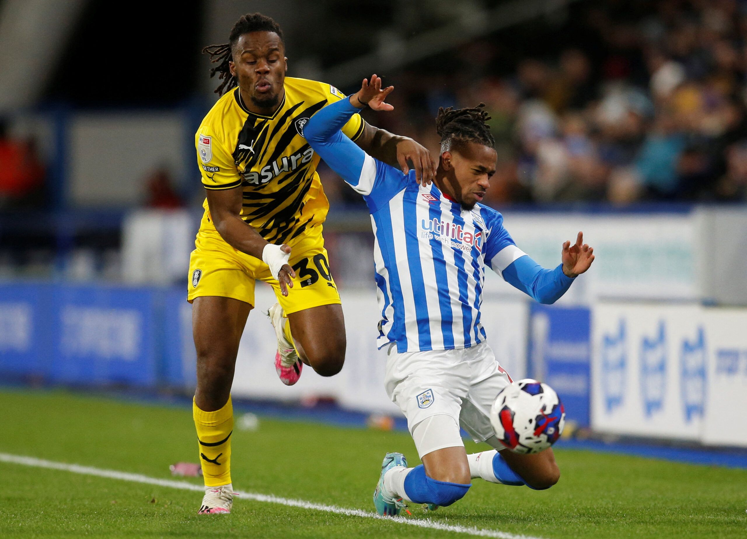 Soccer Football - Championship -  Huddersfield Town v Rotherham United - John Smith's Stadium, Huddersfield, Britain - December 29, 2022 Rotherham United's Peter Kioso in action with Huddersfield Town's David Kasumu Action Images/Ed Sykes  EDITORIAL USE ONLY. No use with unauthorized audio, video, data, fixture lists, club/league logos or 