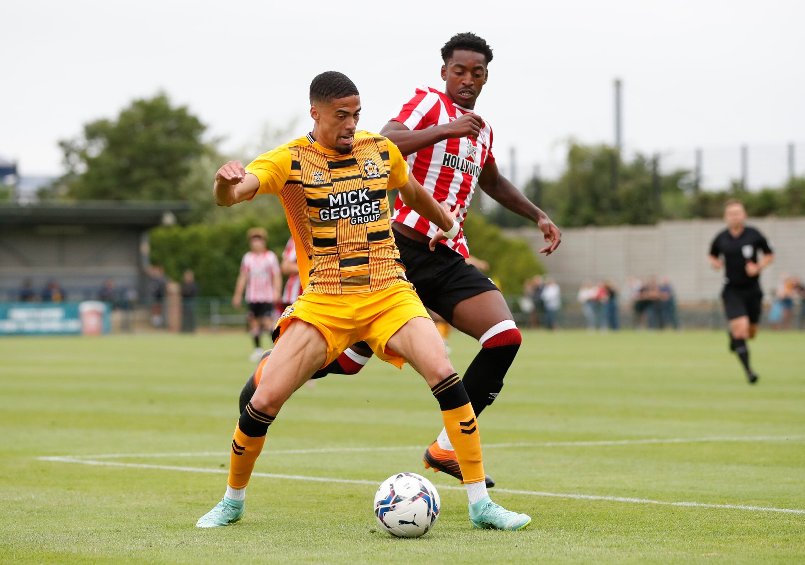 Soccer Football - Pre Season Friendly - Cambridge United v Brentford - Abbey Stadium, Cambridge, Britain - July 23, 2021  Cambridge United's Harvey Knibbs in action with Brentford's Paris Maghoma Action Images via Reuters/Paul Childs