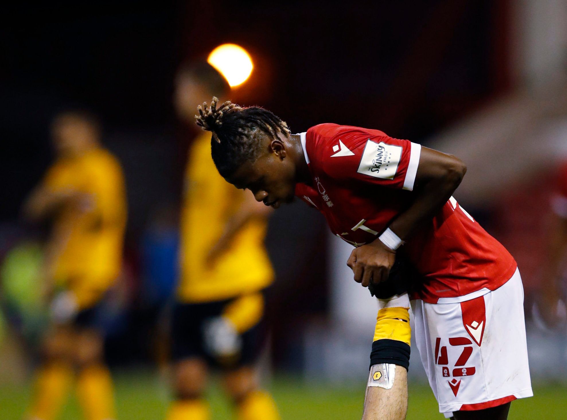 Soccer - England - Carabao Cup Second Round - Nottingham Forest v Wolverhampton Wanderers - The City Ground, Nottingham, Britain - August 24, 2021 Wolverhampton Wanderers' Rayan Ait-Nouri is helped to stretch by Nottingham Forest's Ateef Konate Action Images via Reuters/Andrew Boyers