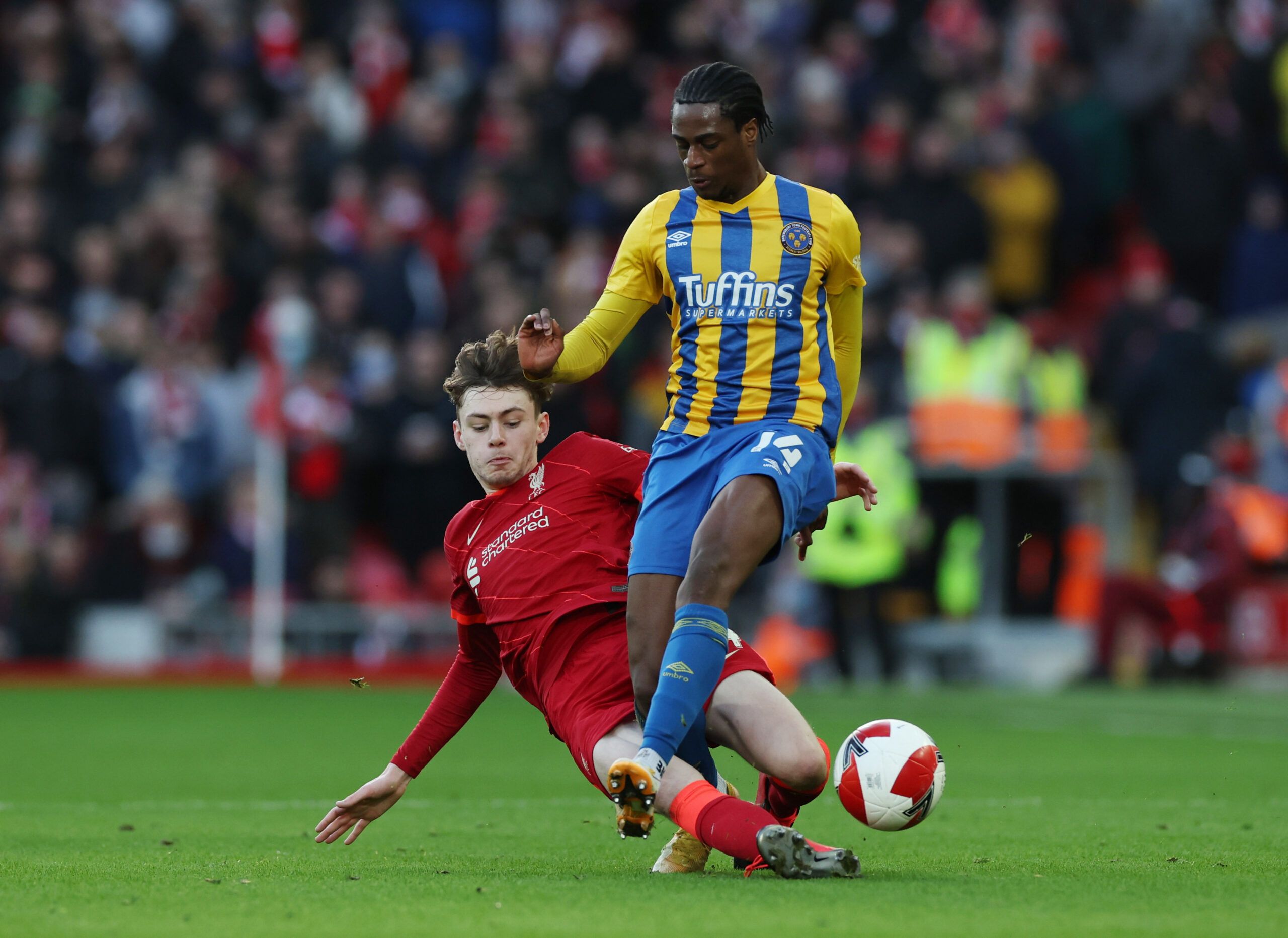 Soccer Football - FA Cup Third Round - Liverpool v Shrewsbury Town - Anfield, Liverpool, Britain - January 9, 2022 Liverpool's Conor Bradley in action with Shrewsbury Town's Nathanael Ogbeta REUTERS/Phil Noble