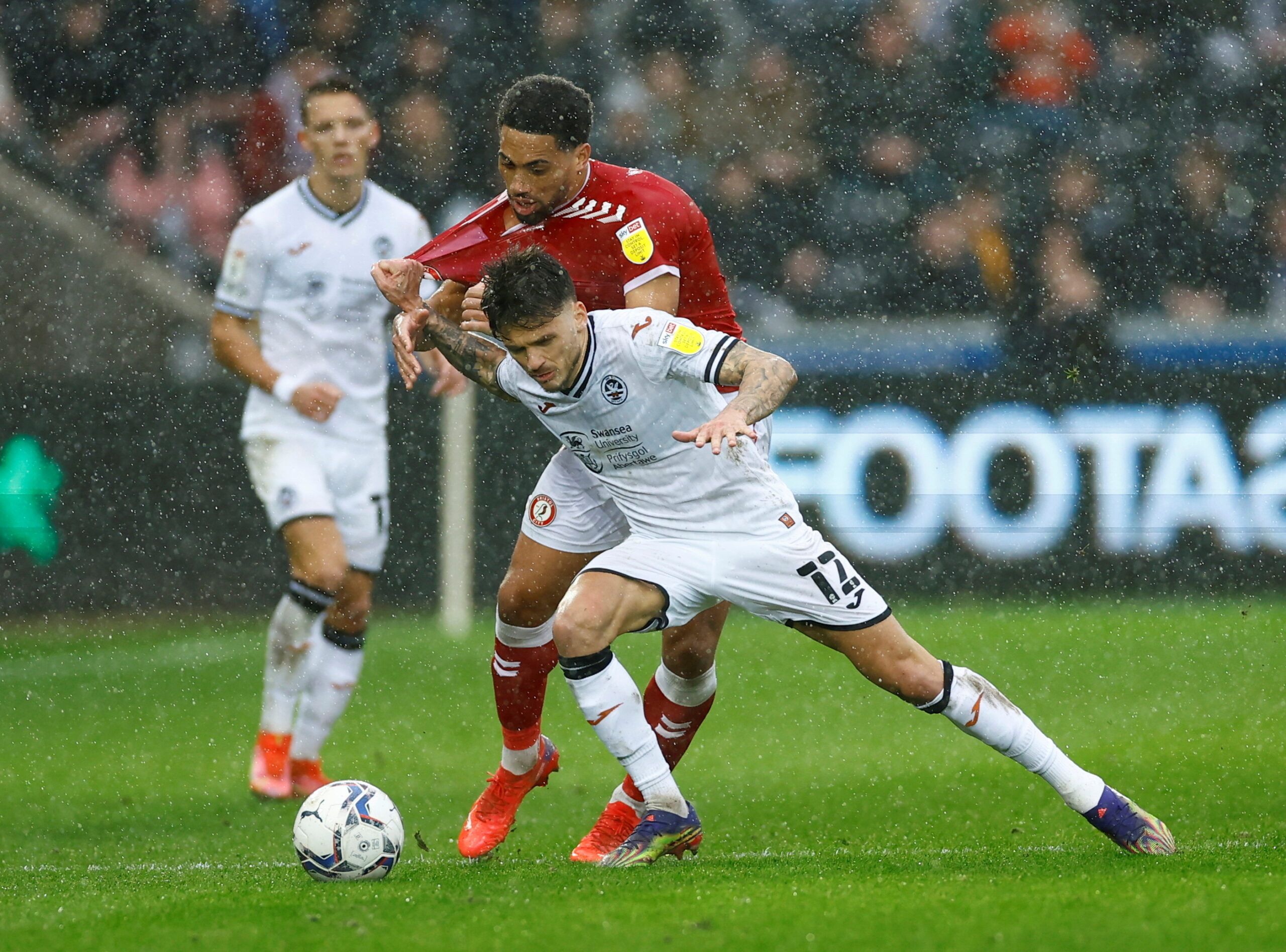 Soccer Football - Championship - Swansea City v Bristol City - Swansea.com Stadium, Swansea, Britain - February 13, 2022  Swansea City's Jamie Paterson in action with Bristol City's Zak Vyner  Action Images/Andrew Boyers  EDITORIAL USE ONLY. No use with unauthorized audio, video, data, fixture lists, club/league logos or 