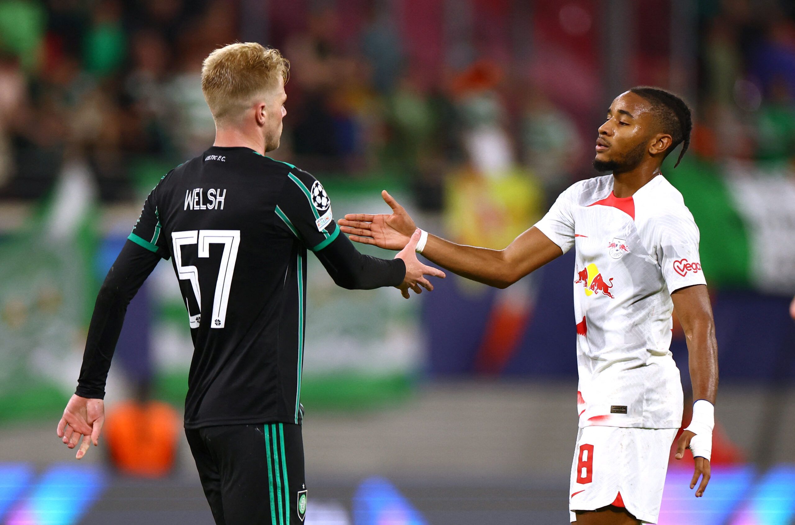 Soccer Football - Champions League - Group F - RB Leipzig v Celtic - Red Bull Arena, Leipzig, Germany - October 5, 2022 RB Leipzig's Christopher Nkunku shakes hands with Celtic's Stephen Welsh after the match REUTERS/Lisi Niesner