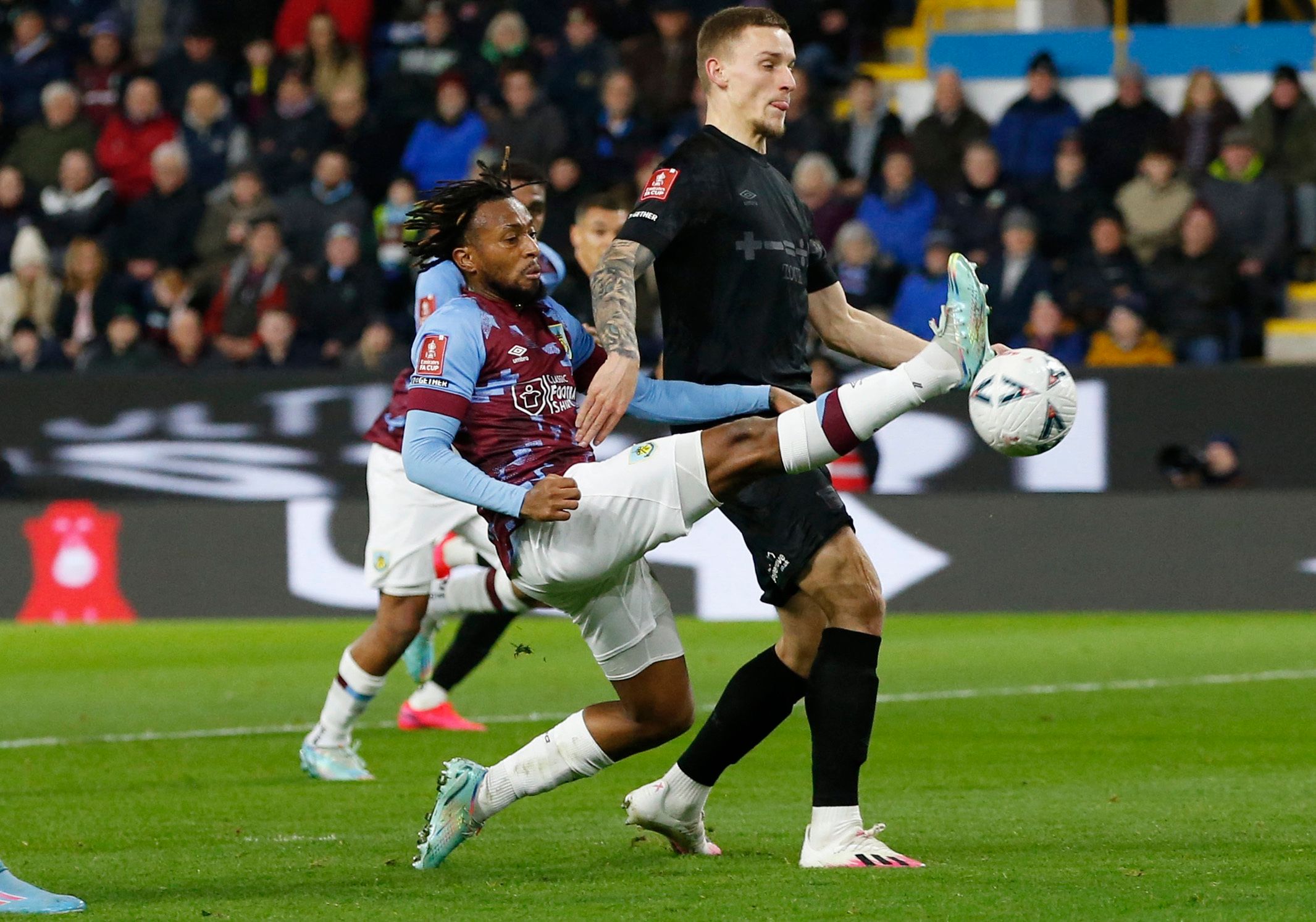 Soccer Football - FA Cup Fourth Round Replay - Burnley v Ipswich Town - Turf Moor, Burnley, Britain - February 7, 2023 Burnley's Samuel Bastien in action with Ipswich Town's Luke Woolfenden Action Images/Ed Sykes