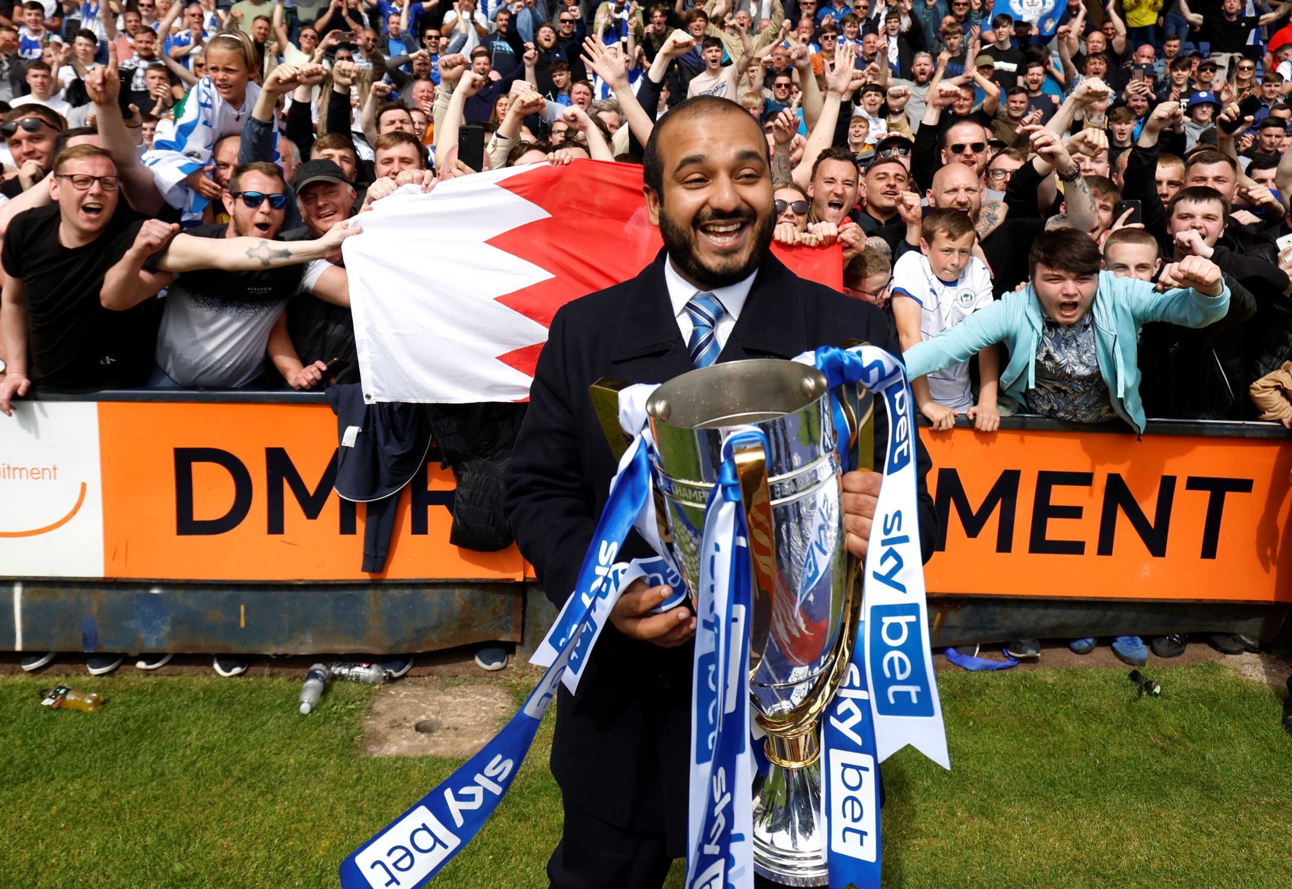 Soccer Football - League One - Shrewsbury Town v Wigan - Montgomery Waters Meadow, Shrewbury, Britain - April 30, 2022 Wigan Athletic chairman Talal Al-Hammad celebrates winning League One with the trophy    Action Images/Jason Cairnduff  EDITORIAL USE ONLY. No use with unauthorized audio, video, data, fixture lists, club/league logos or 