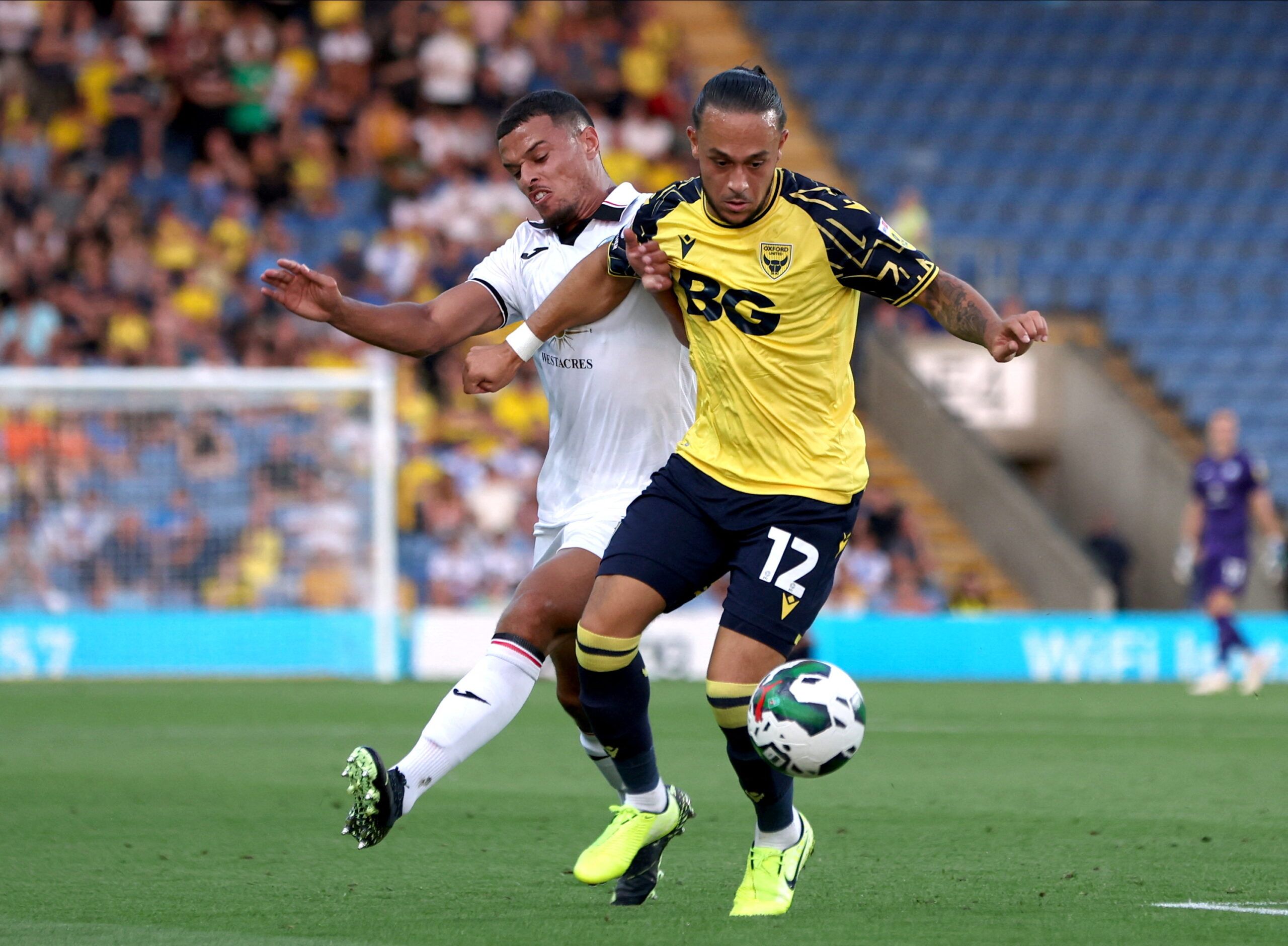 Soccer Football - Carabao Cup - Oxford United v Swansea City - Kassam Stadium, Oxford, Britain - August 9, 2022  Oxford United's Jodi Jones in action with Swansea City's Joel Latibeaudiere Action Images/Paul Childs  EDITORIAL USE ONLY. No use with unauthorized audio, video, data, fixture lists, club/league logos or 