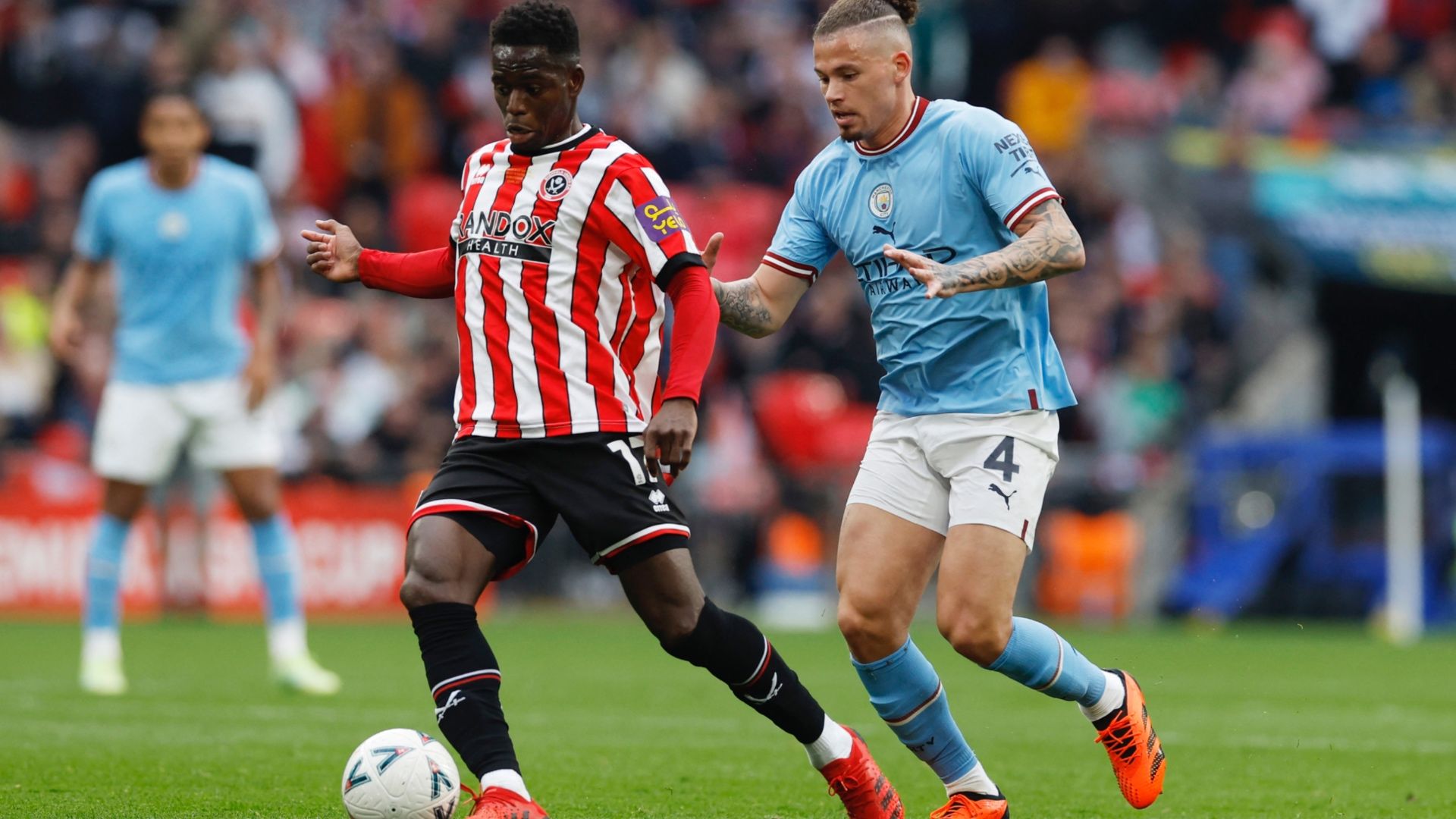 Ismaila Coulibaly of Sheffield United with Man City’s Kalvin Phillips