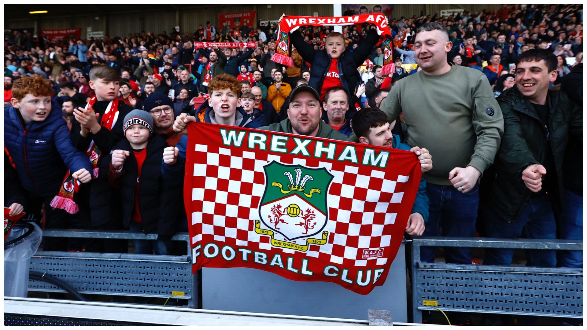 Soccer Football - National League - Wrexham v Notts County - Racecourse Ground, Wrexham, Britain - April 10, 2023 Wrexham fans in the stand celebrate after the match Action Images/Andrew Boyers