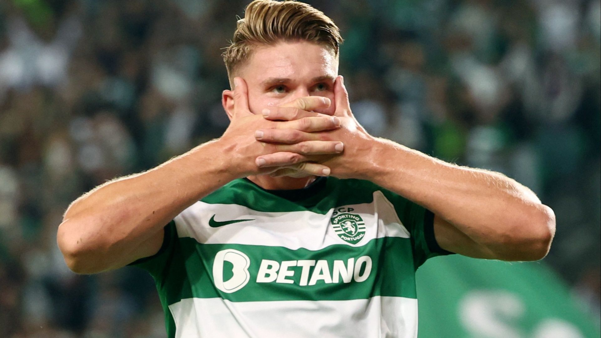  Viktor Gyokeres, a Swedish professional footballer who plays as a striker for Primeira Liga club Sporting CP, celebrates a goal with his hands covering his mouth.