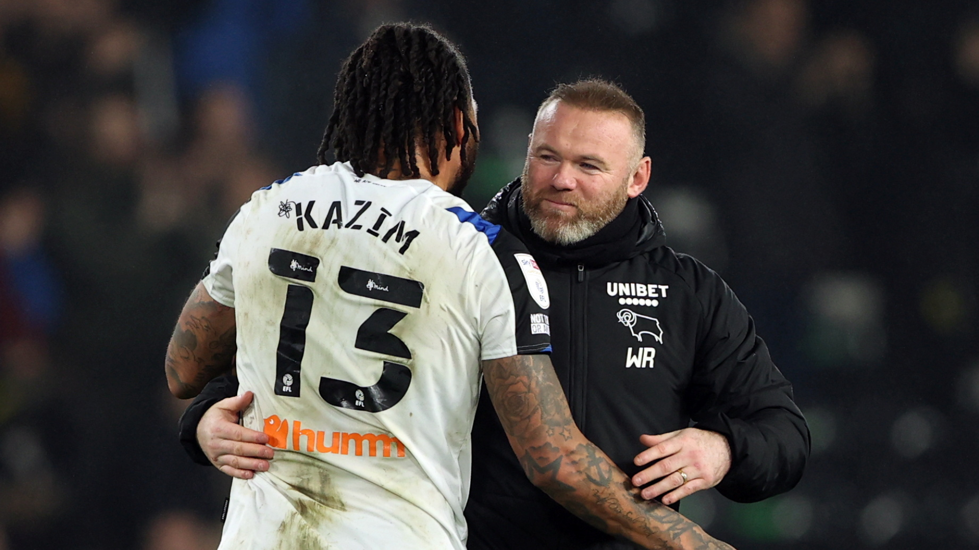 Colin Kazim-Richards embracing Wayne Rooney