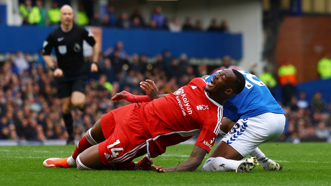Callum Hudson-Odio is tackled by Ashley Young inside the area