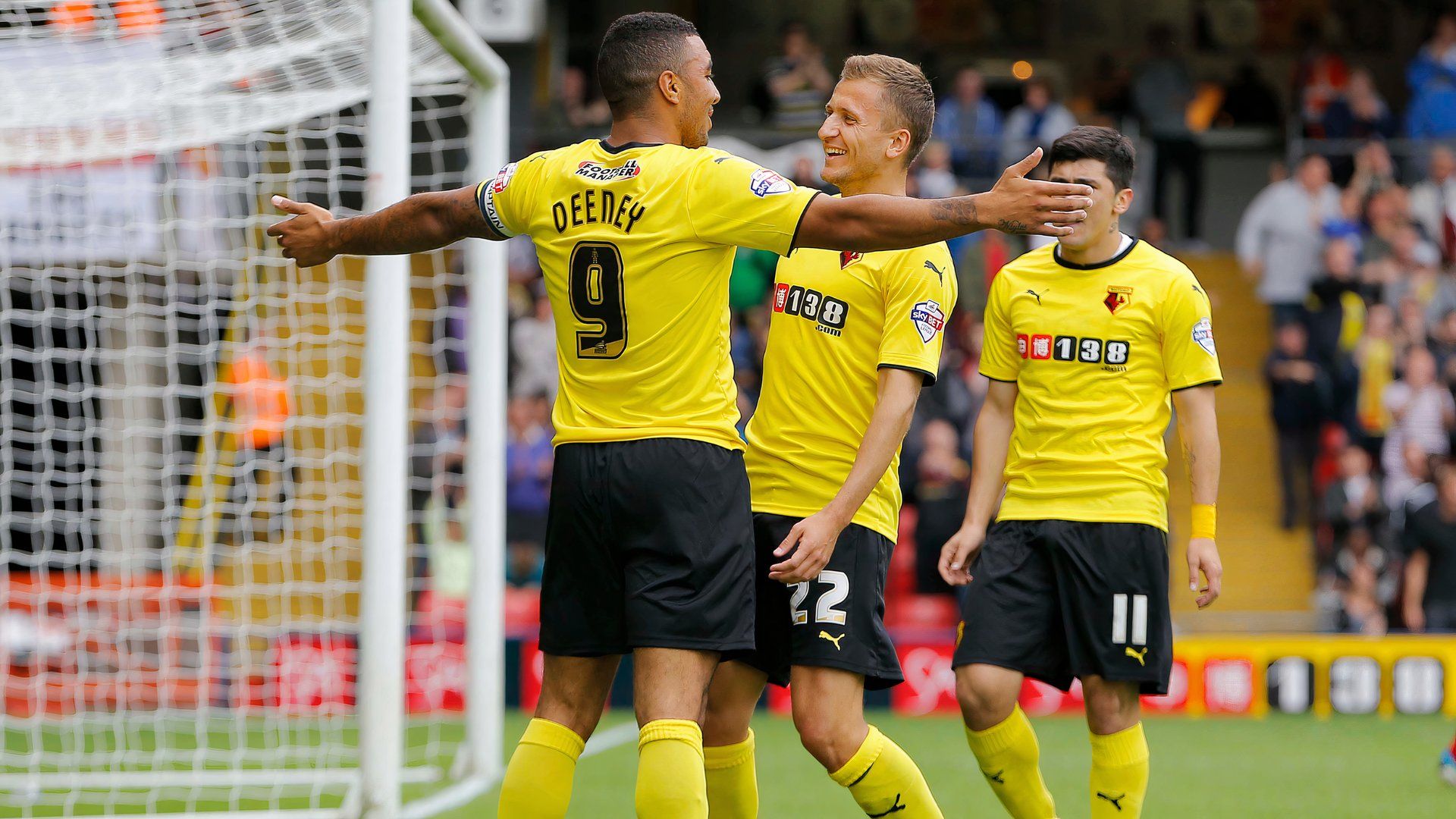 Troy Deeney celebrates with his Watford teammates Almen Abdi and Fernando Forestieri