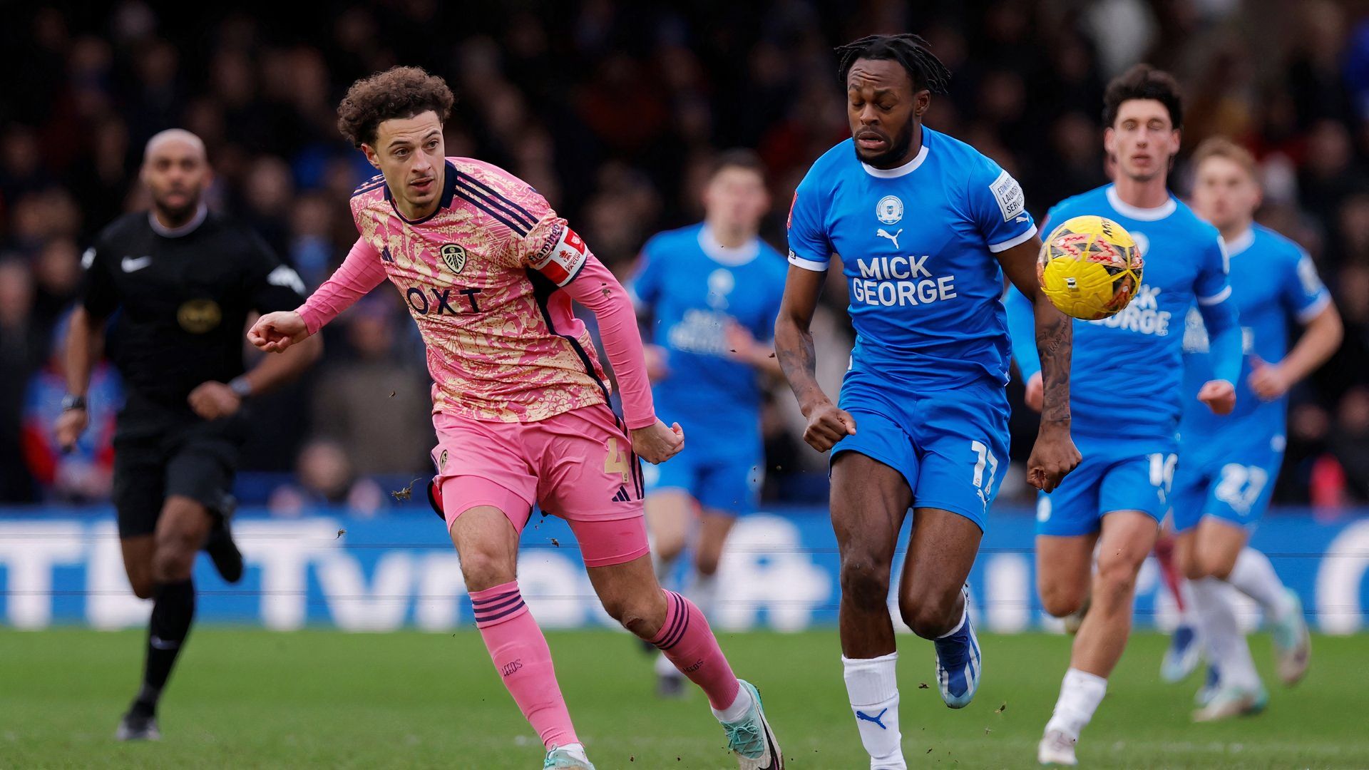 Peterborough United's Ricky-Jade Jones battles with Leeds United's Ethan Ampadu