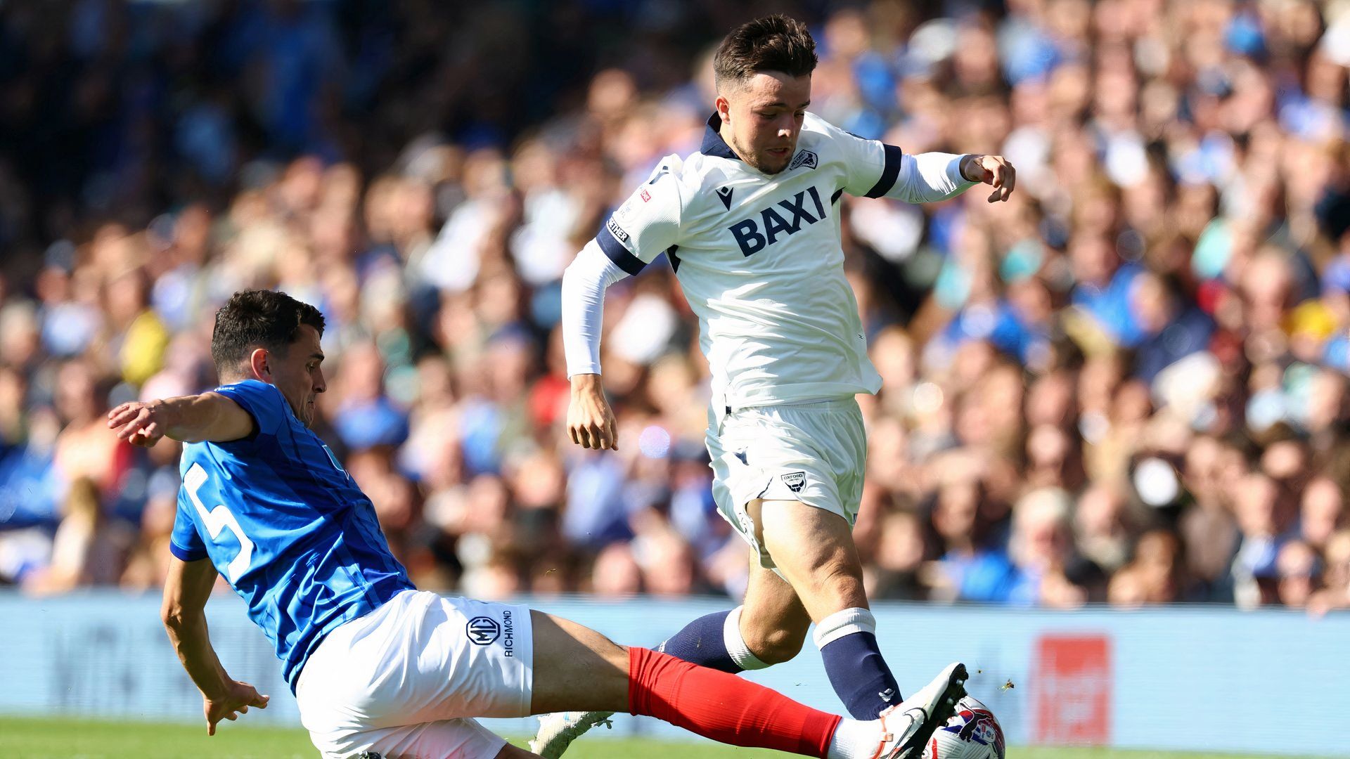 Portsmouth's Regan Poole in action with Oxford United's Tyler Goodrham