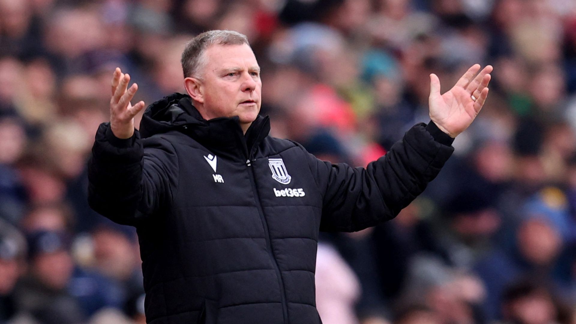 Mark Robins as Stoke City manager with both arms raised