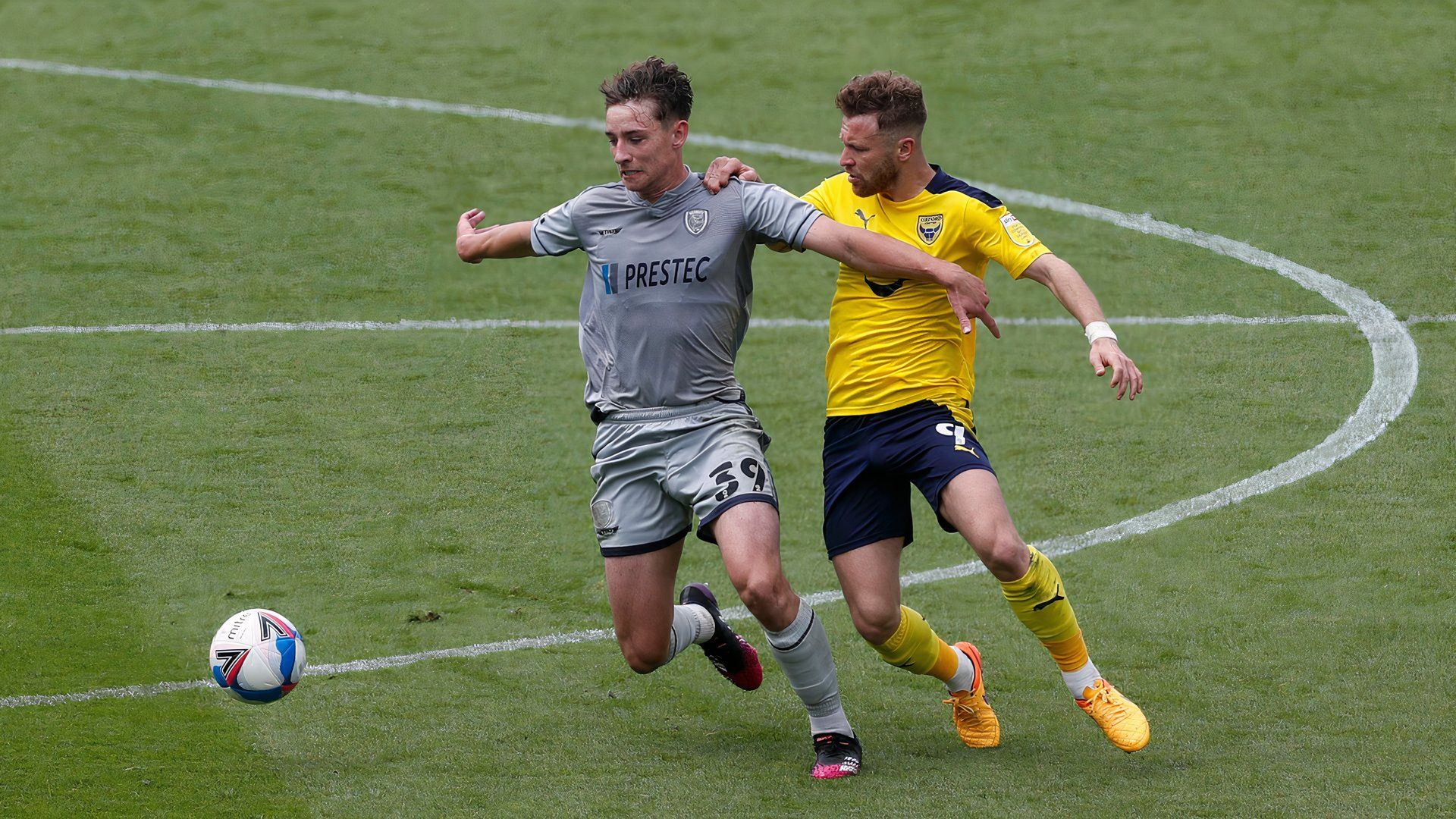 Oxford United's Matty Taylor in action with Burton Albion's Terry Taylor