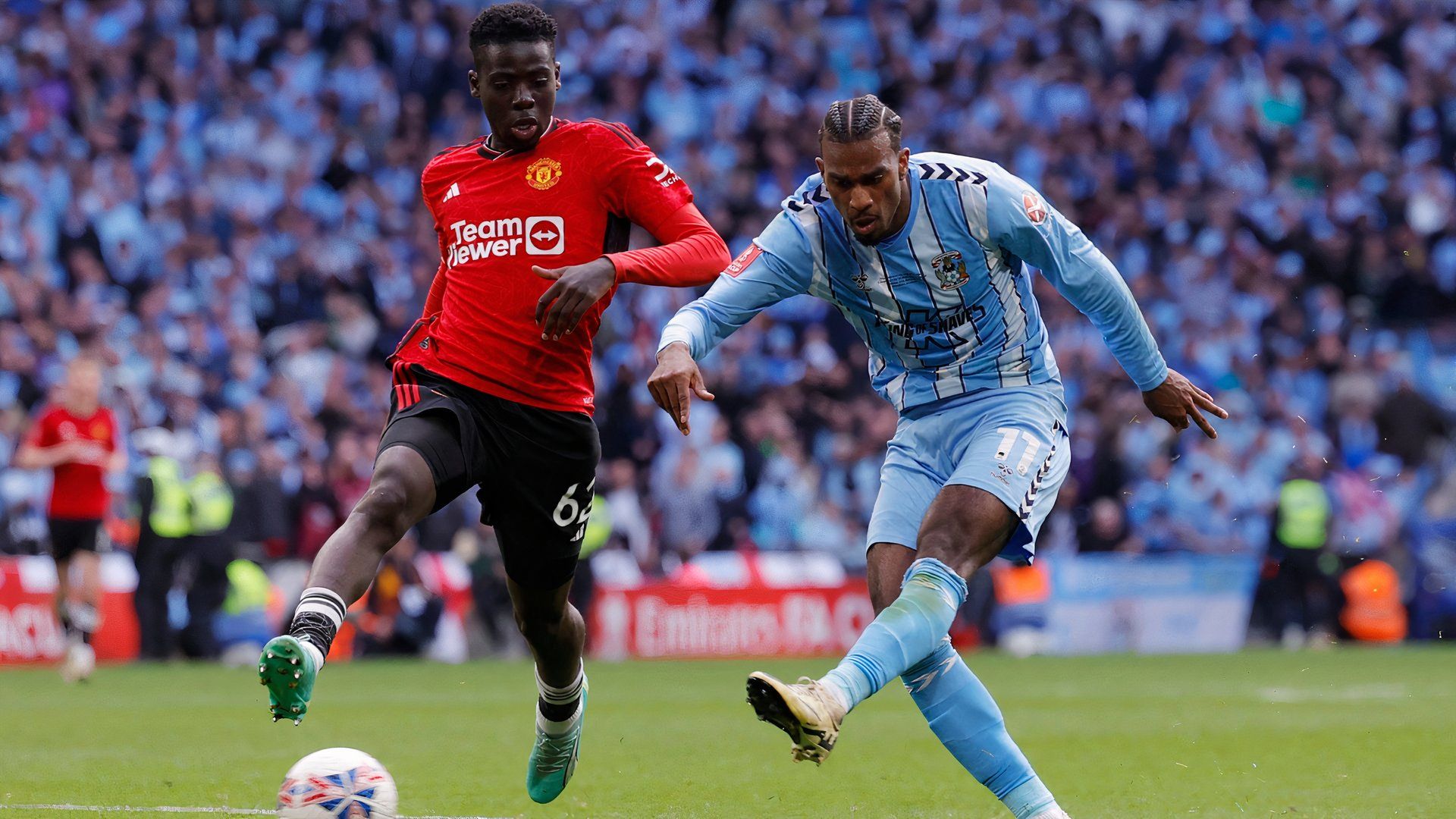 Manchester United's Omari Forson in action as Coventry City's Haji Wright shoots at goal
