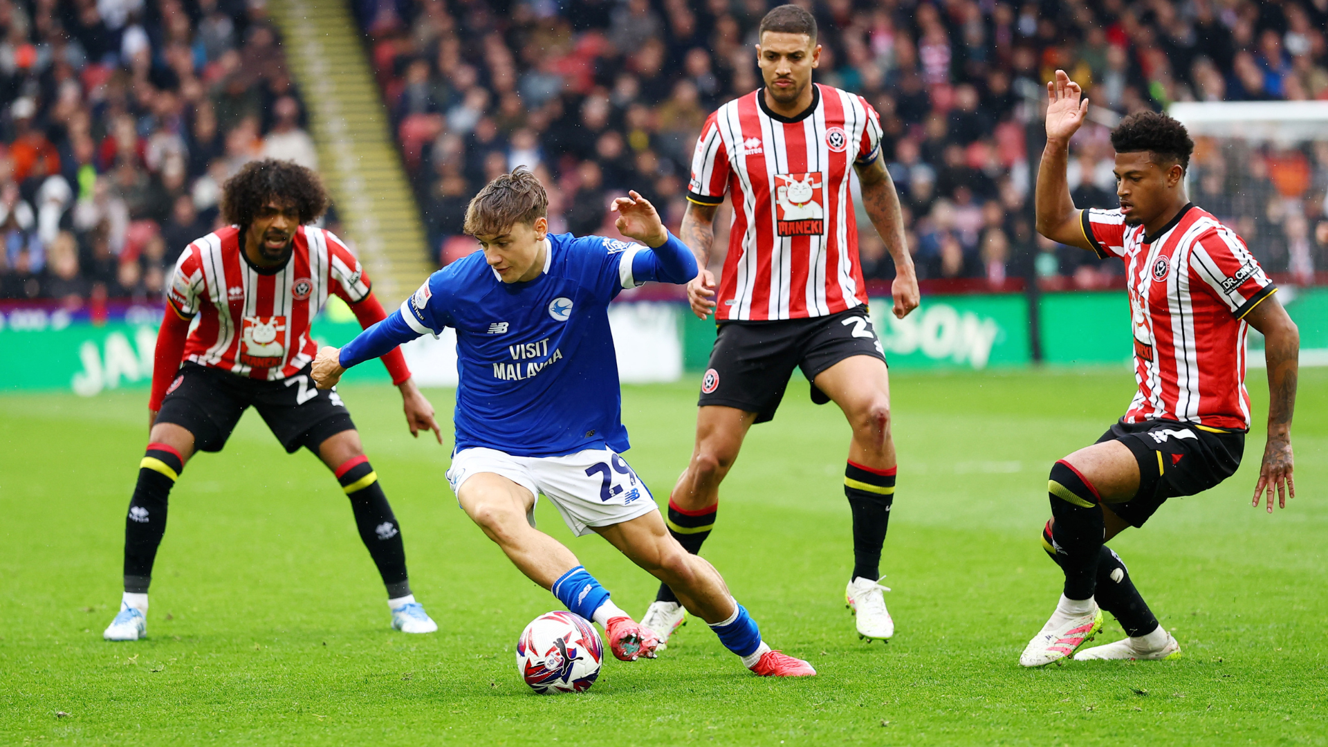 Will Alves of Cardiff City surrounded by Sheffield United players during their match in April 2025