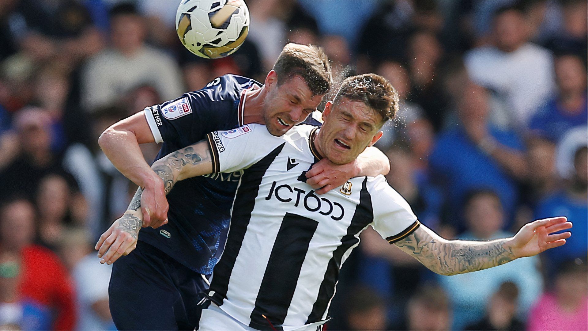 Andy Cook challenges for a header